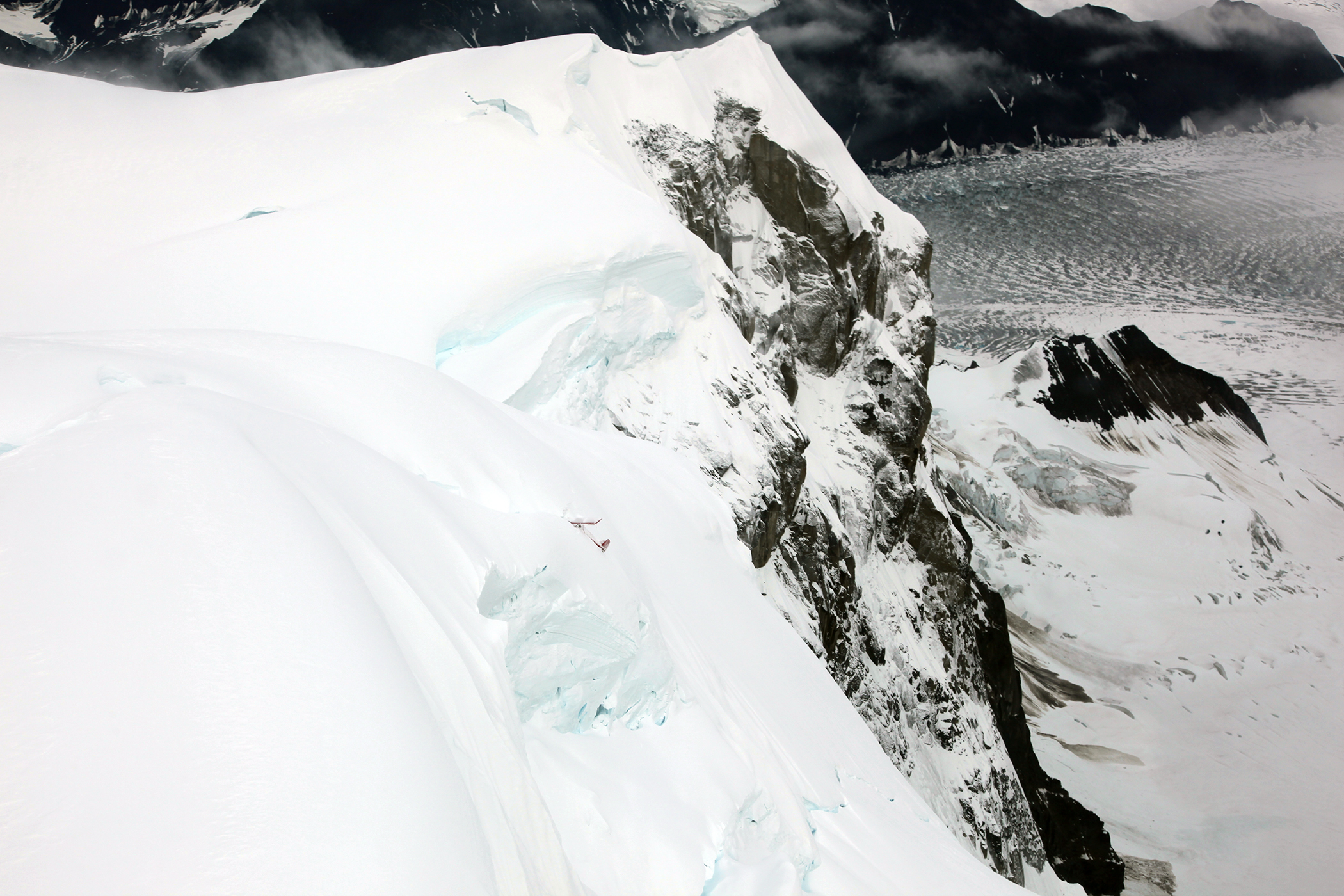 thunder mountain crash site crashed plane on the side of a very steep and snow-covered mountain