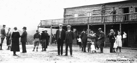 Historic image of people near wood building