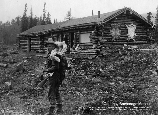 Man with a gun and animal pelt