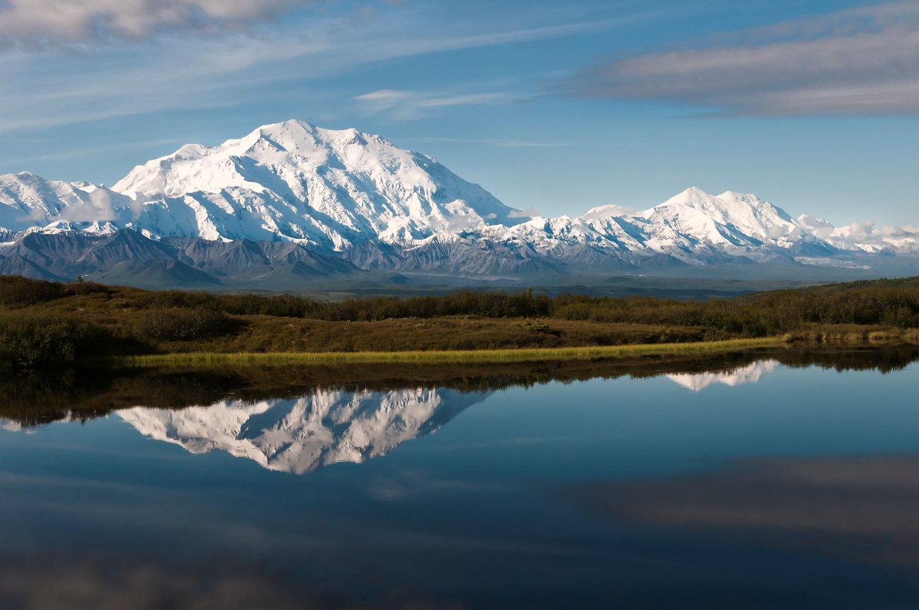 huge snowy mountain reflected in a pond