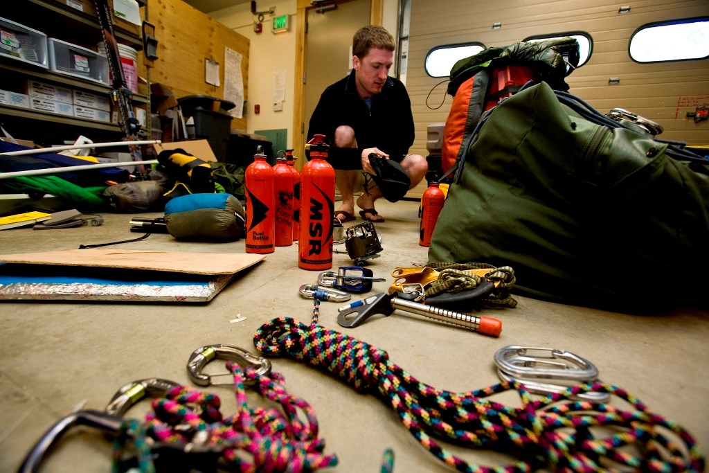 Climber sorting gear in a garage