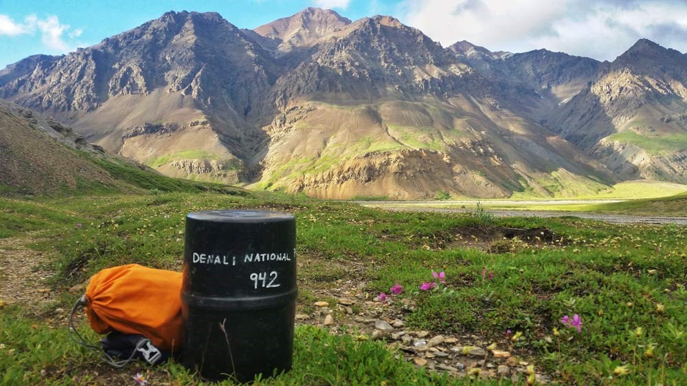 closeup of a plastic cylinder about 18" tall with text on it identifying it as property of Denali National Park