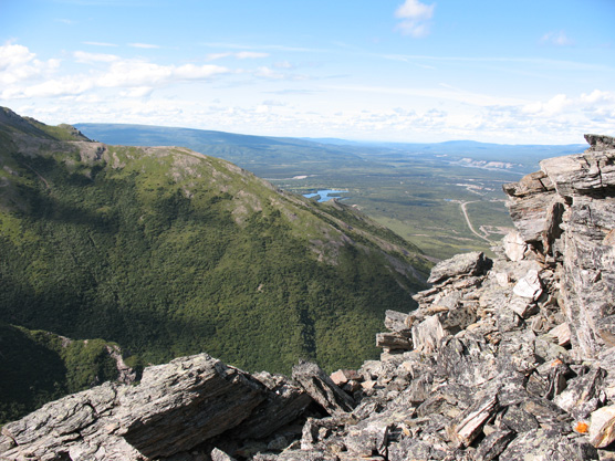 the view down a mountainside toward a lake and small town