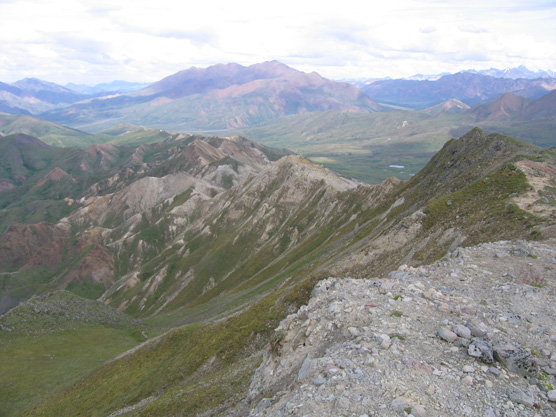 a mountain ridge covered in green vegegation