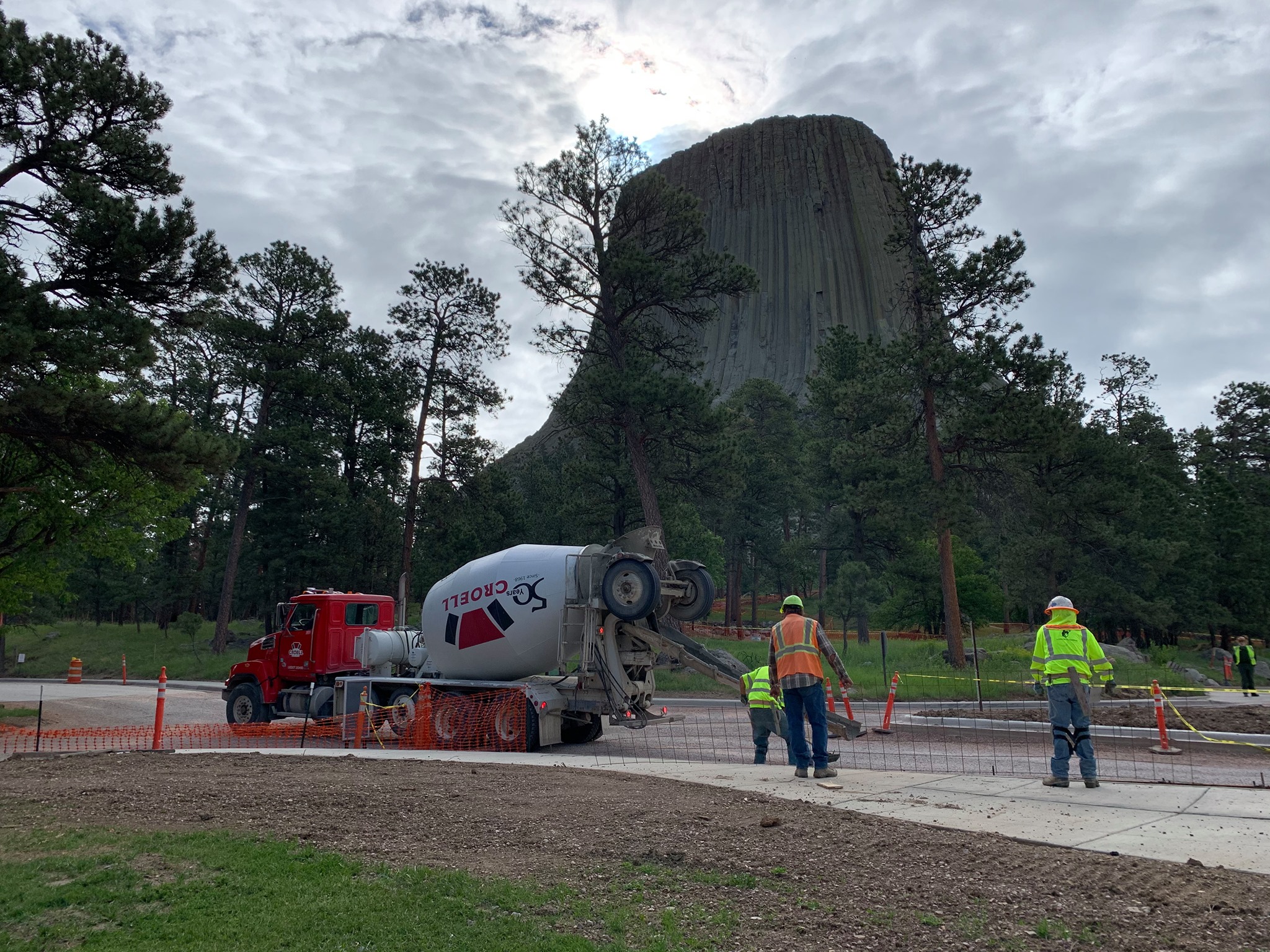 103650178_4226725440671760_4210509604481710855_o Concrete truck dispersing wet cement as large rock monolith hovers in the background