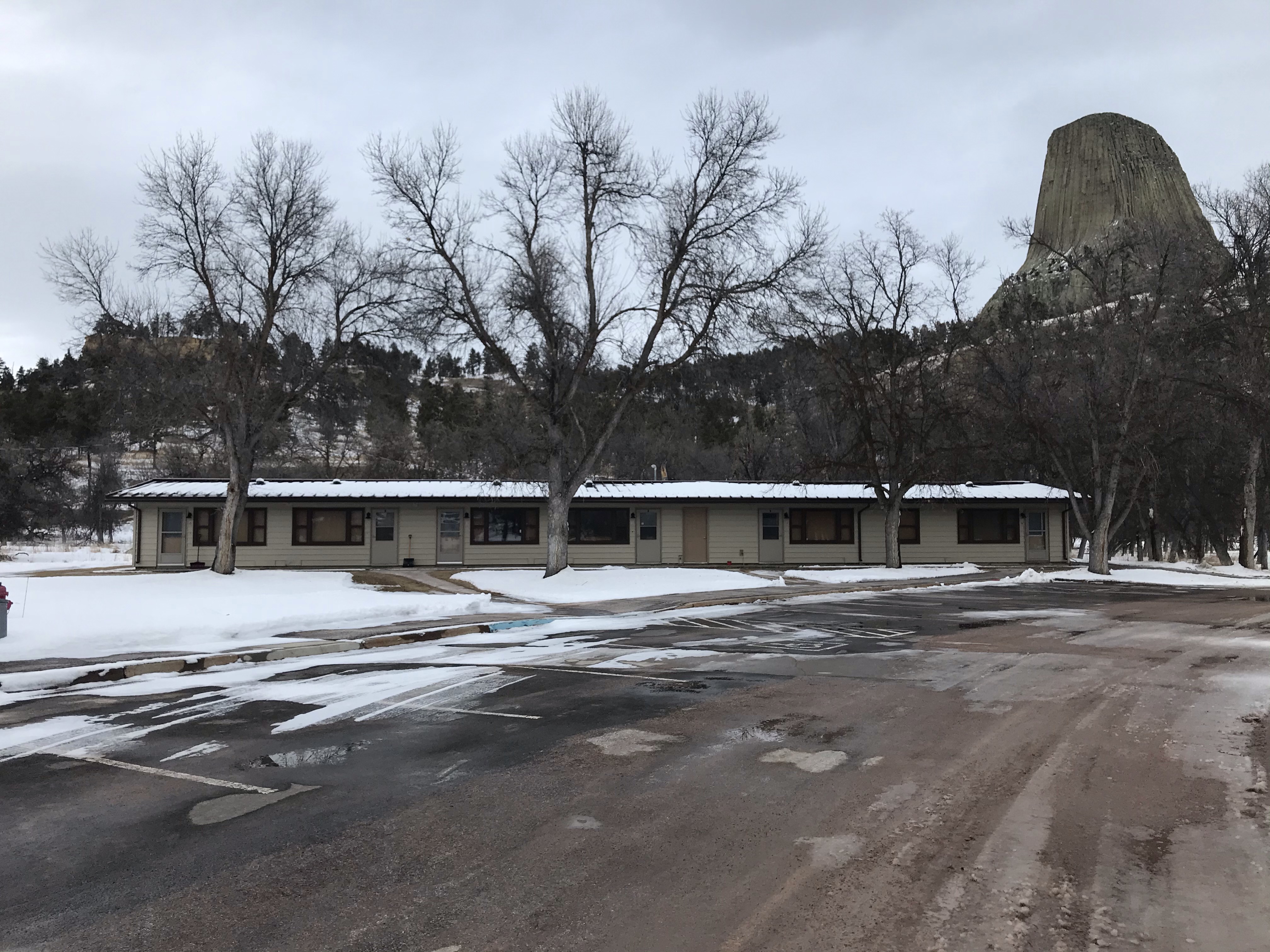 Current Employee Housing Unit NPS Photo Single level apartment complex with large rock monolith in the background.