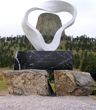 Devils Tower framed through a white sculpture representing a smoke ring
