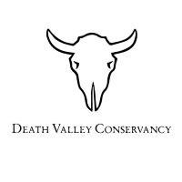 White bighorn sheep skull and words underneath that say Death Valley Conservancy on a black background.