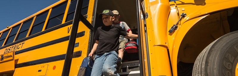 A child exits a bus in Death Valley.