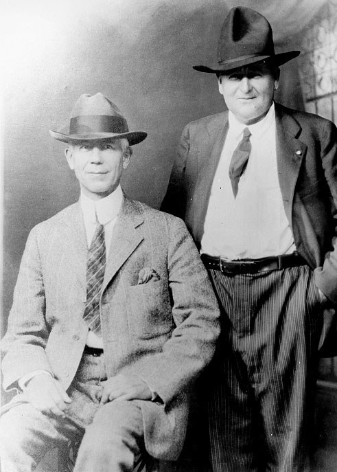 two men in suits in a historic photograph