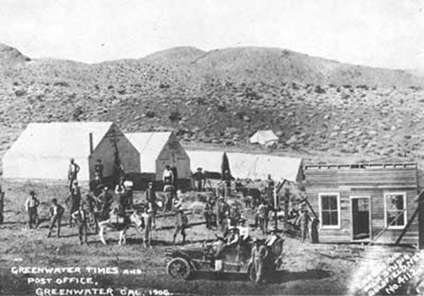 historic photo of tents and old auto and miners