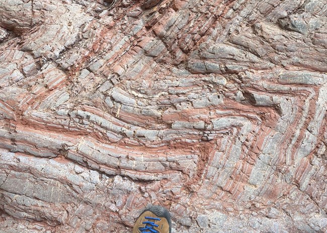 red and white rock layers in a chevron pattern