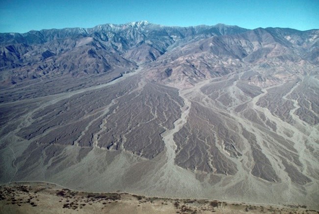 an aerial photograph showing a line across an alluvial fan