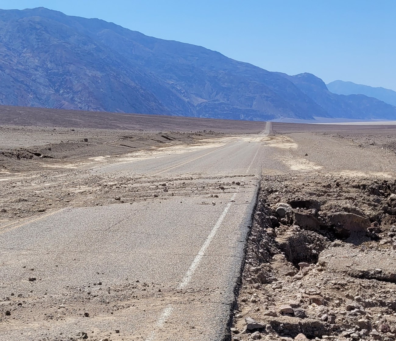 Gravel and small rocks on a paved road.