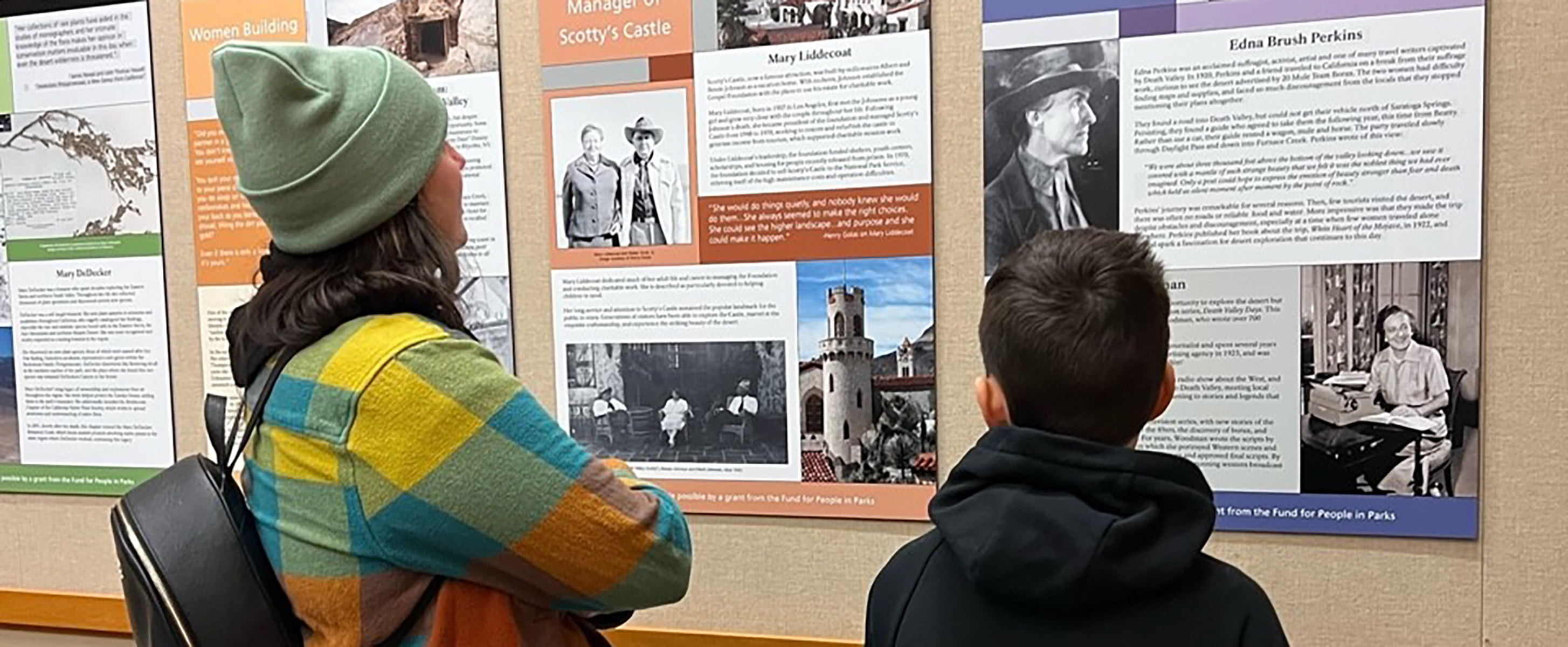 A young man and his mother reading the “Women of Change” exhibit. The young man thought Edna Brush Perkin’s had a compelling story to share.