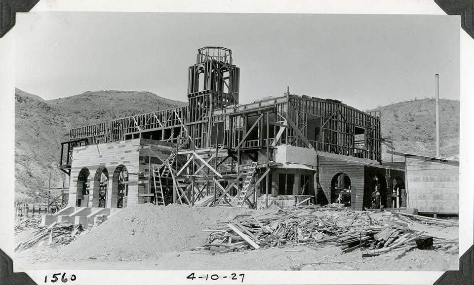 DEVA 40466 Black and white photo of a two-story building under construction, surrounded by scaffolding. "1560" and "4-10-27" are hand-written on the bottom.