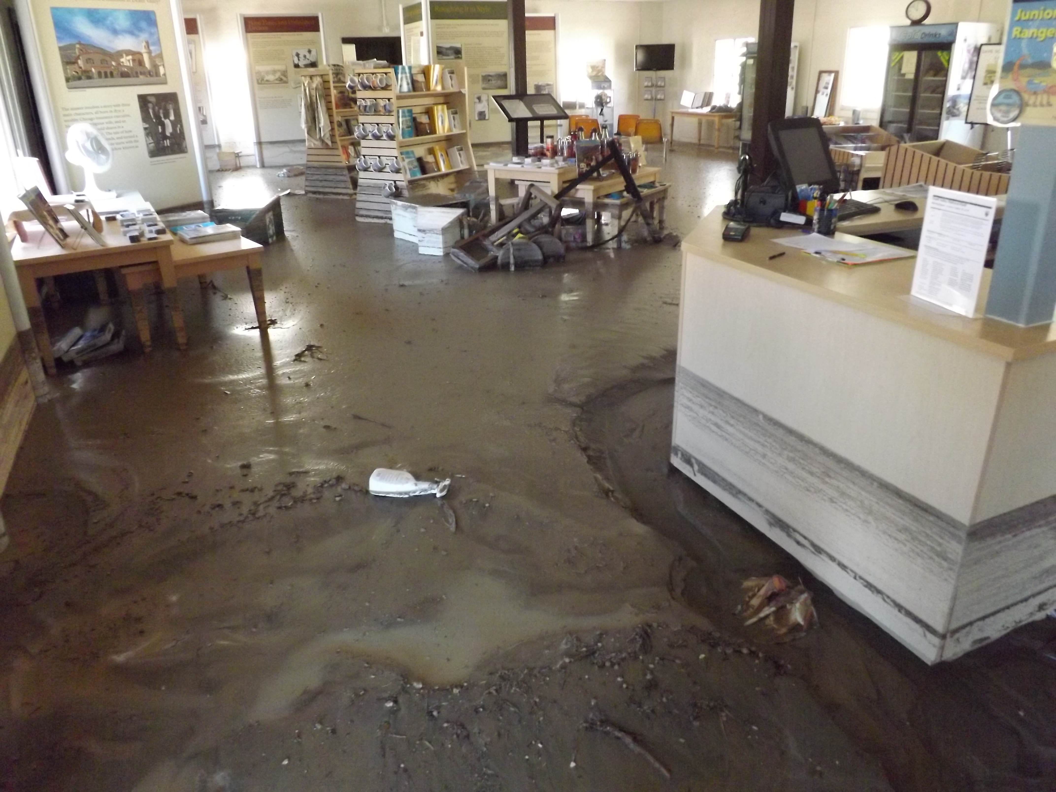 The main room of the visitor center, including the front desk and the gift store, with about one foot of mud covering the entire floor.