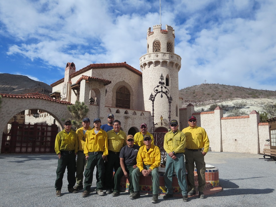 Employees from Mesa Verde pause for a photograph in front of Scotty's Castle. They are normally a fire crew and are wearing yellow Nomex shirts.