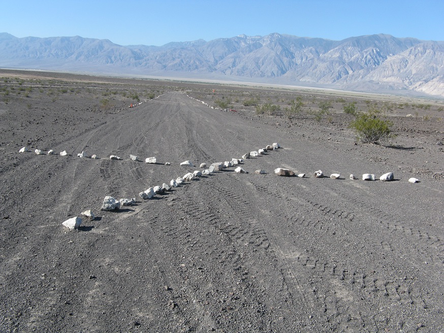 A large X, made out of white stones, signals to pilots that the landing strip is closed.