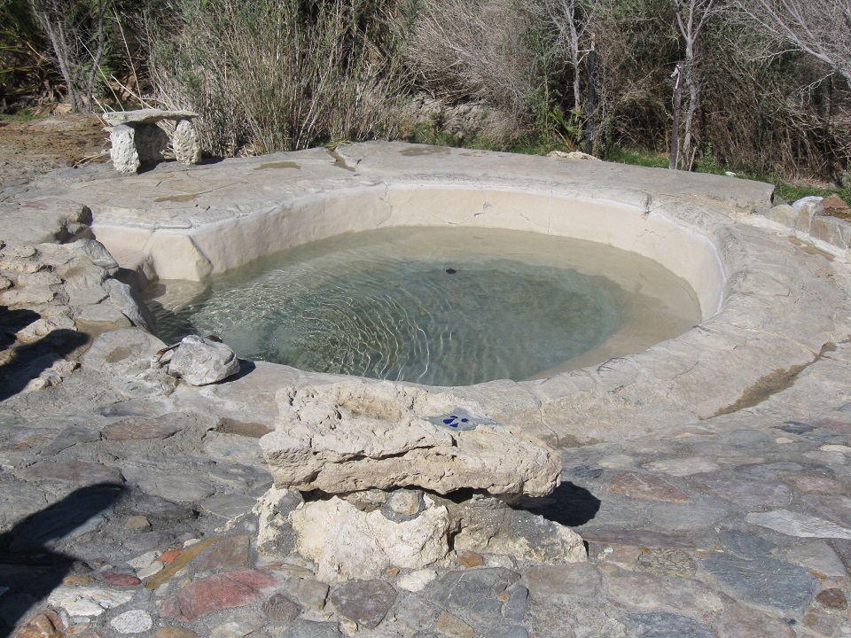 The Sunrise Pool is a circular man-made tub that is surrounded by flagstone.