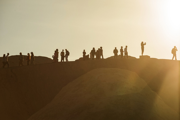 Visitors stand on a ridge at Zabriskie Point