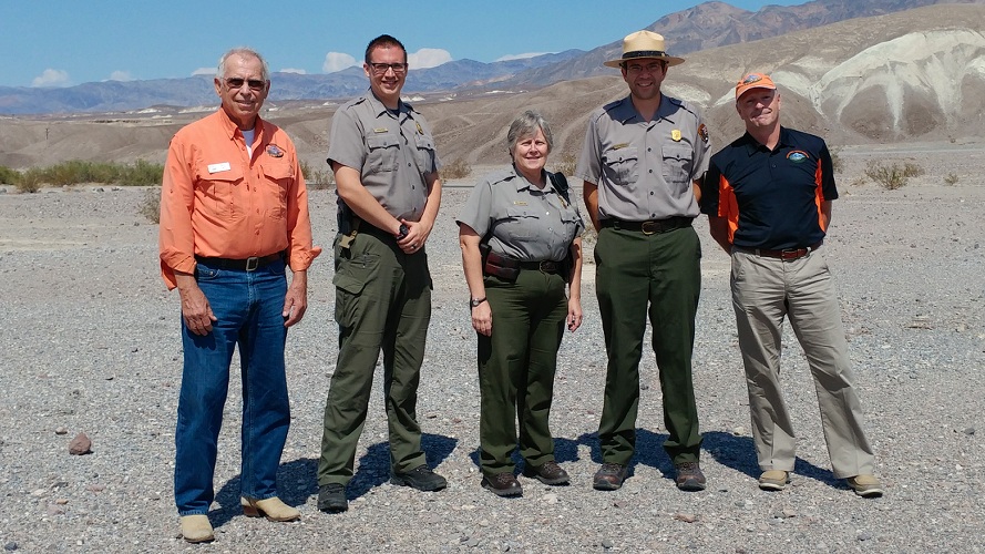 Superintendent Mike Reynolds and other NPS employees stand for a photo with two men from RAF.