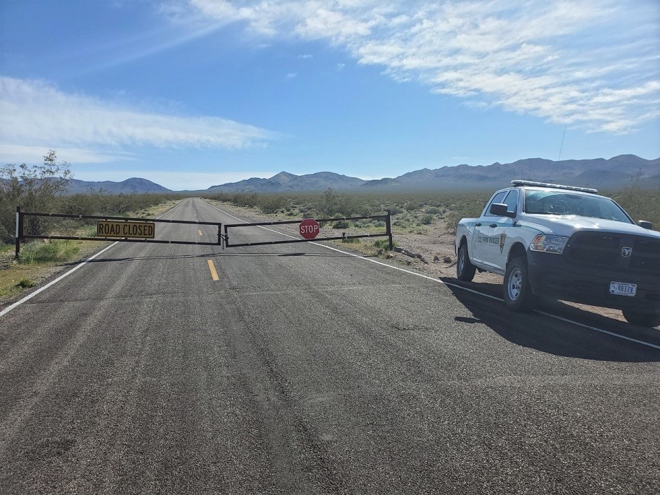 Closed gate with a ranger patrol truck