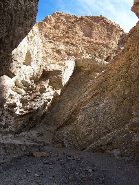 A large dry waterfall blocks passage inside a canyon