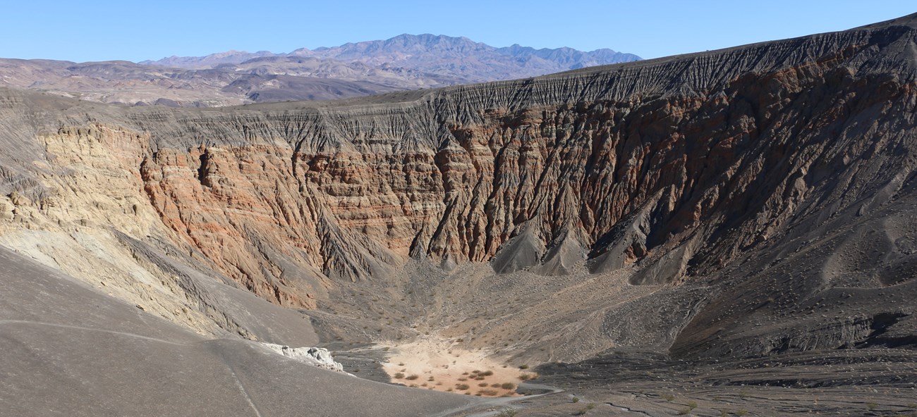 a cater with a dry orange lakebed at the bottom