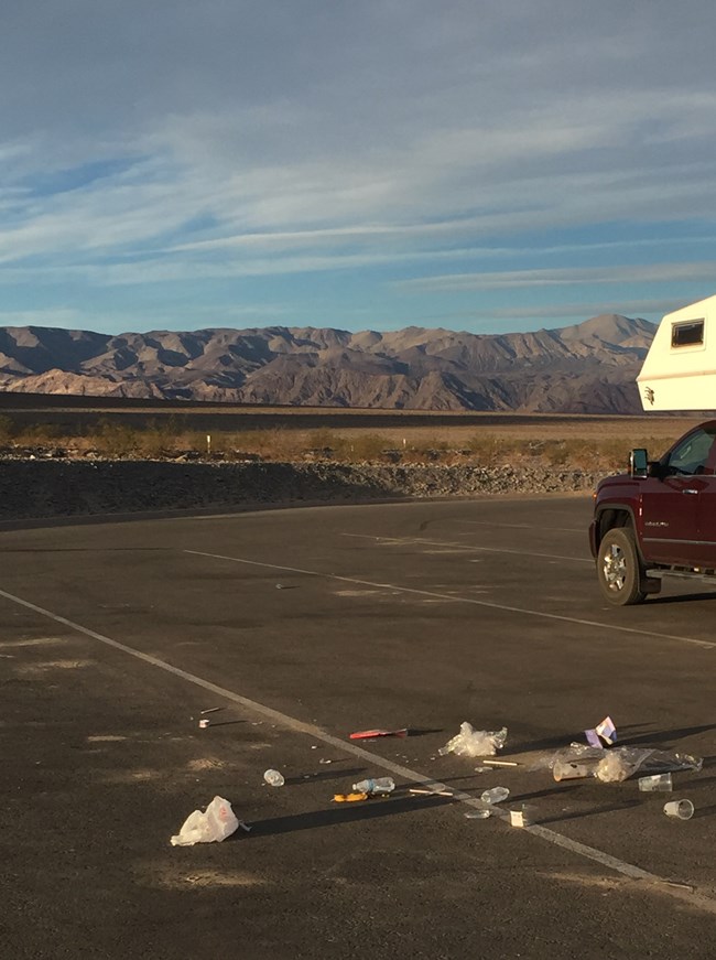 An empty parking lot with food waste scarttered around.