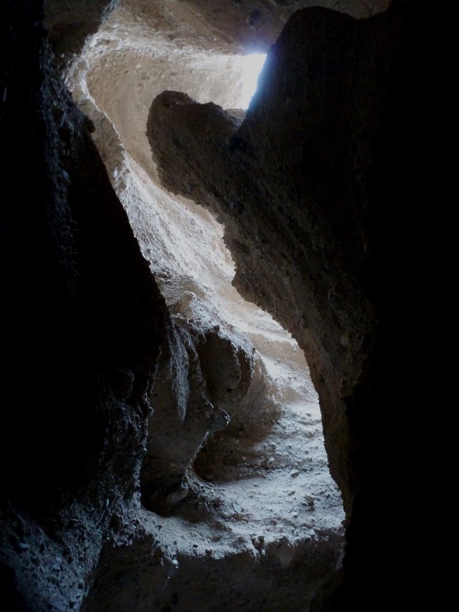 Light from above filter through narrow canyon roof.