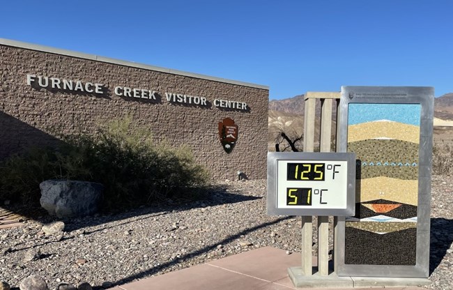 Thermometer reading 125 F/ 51 C in front of Furnace Creek Visitor Center