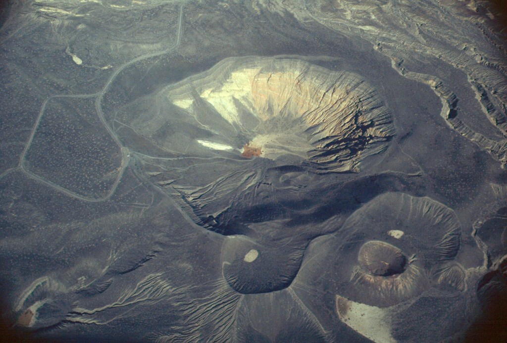 an aerial view of two adjacent craters