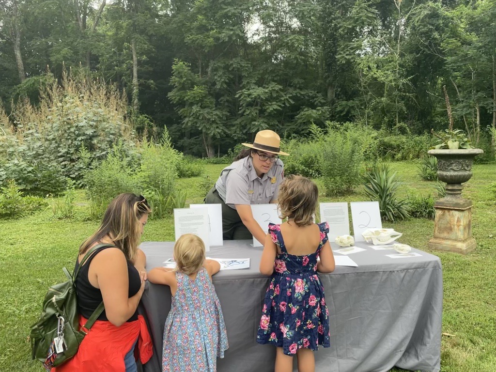 A ranger helping students learn about animals at Science Summer Camp.