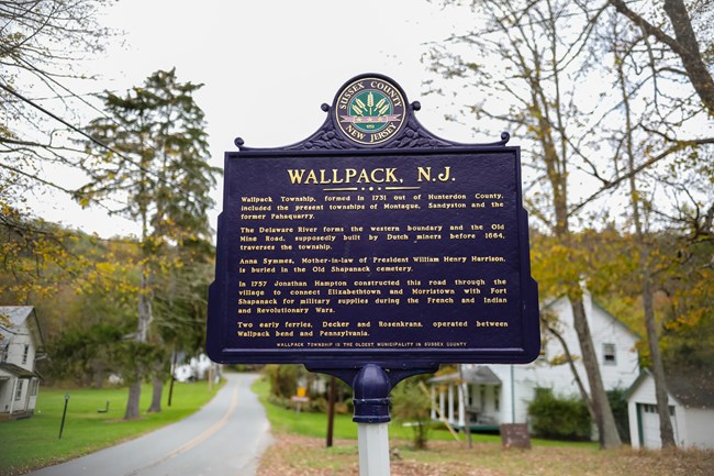 Historic marker for Walpack Center with the village in the background.