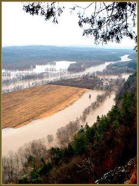 Farm fields alongside a river and partially under water from a flood