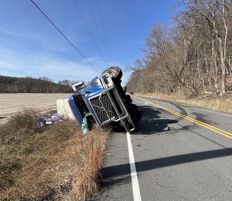 Tractor Trailer Wreck on 209 April 2 2025 A blue-cabbed tractor trailer flipped on its side along route 209.