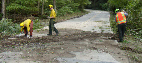 crew raking debris from roadway