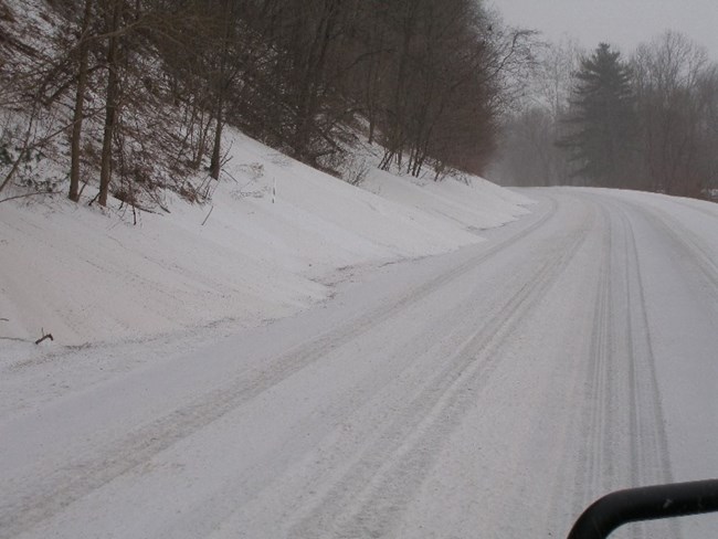 Route 209 completely covered in snow during a storm.