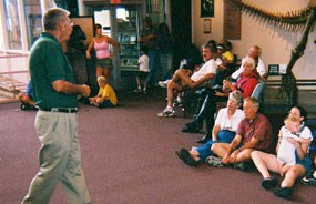 Volunteer speaking to visitors.