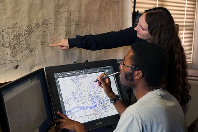 Using digitizing monitors and GIS software interns Nicole and Ben are converting and merging old quarry paper maps into a single electronic master map of one of the world’s greatest dinosaur quarries.
