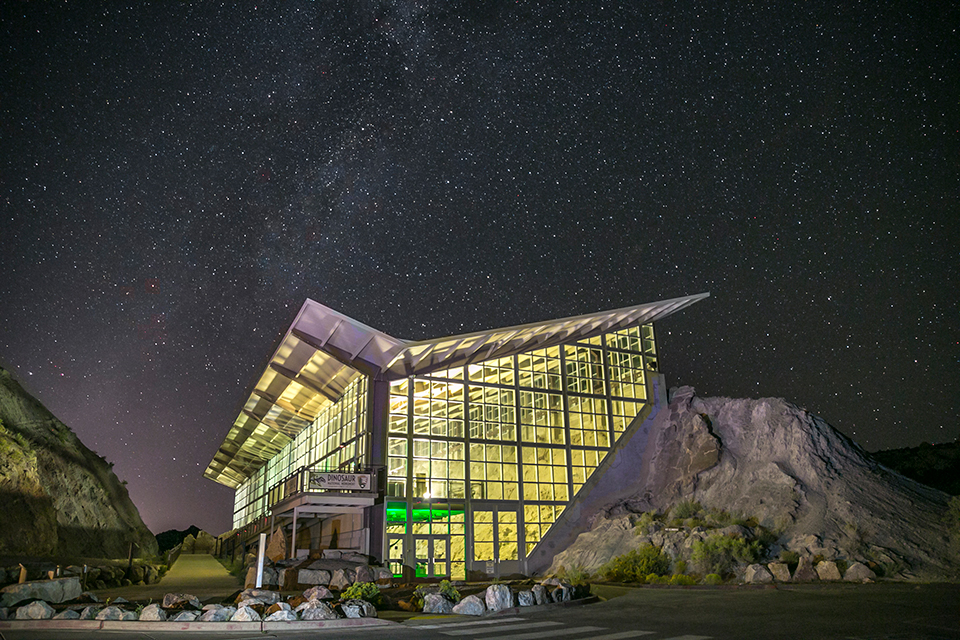 A starry sky fills the sky above the monument's Dinosaur Quarry Exhibit Hall.