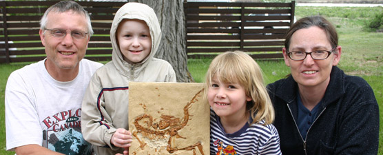 Nathan and his family with a cast of Compsognathus