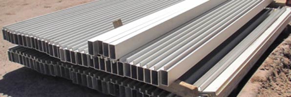 White beams are stacked on the ground to be used in the new east curtain wall. 