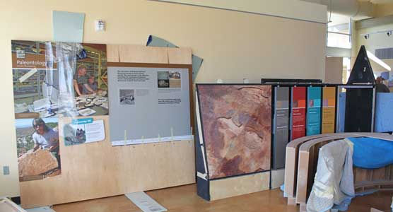 New exhibits at the Quarry Visitor Center, some leaning against walls and some still wrapped, await installation.