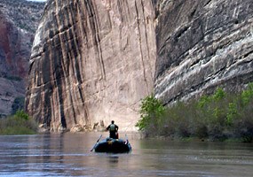 A rafter passes by Steamboat Rock