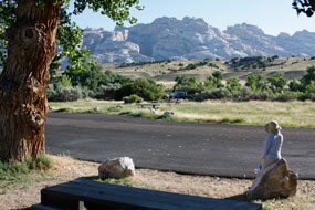 Road running through Green River Campground with campsites in distance.