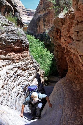 A hiker climbs some of the rocky slopes in Lower Sand Canyon. A hiker climbs some of the rocky slopes in Lower Sand Canyon.