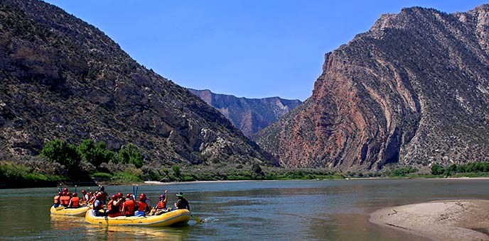 A rafting day trip floats towards the upturned rock layers of Split Mountain near Rainbow Park. A rafting day trip floats towards the upturned rock layers of Split Mountain near Rainbow Park.