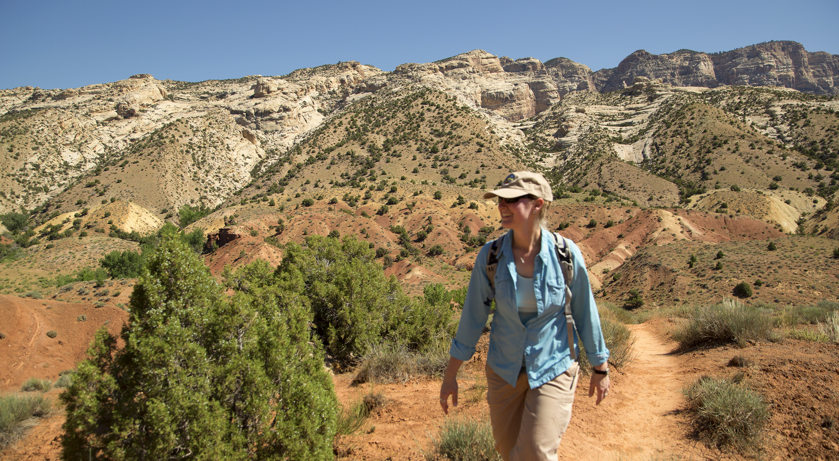 Woman hiking with mountains in the background. Woman hiking with mountains in the background.